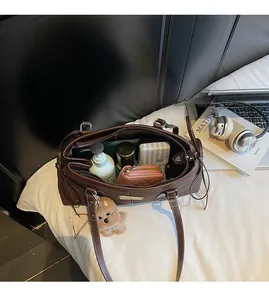 Spacious interior of a dark brown tote bag holding cosmetics, wallet, and accessories