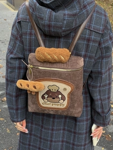 Brown corduroy backpack with chef puppy embroidery and caramel plush detail