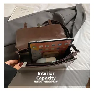Detailed view of the large interior capacity of a vintage brown leather crossbody bag