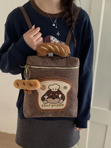 Deep brown corduroy fashion backpack with cute chef puppy embroidery and plush baguette charm