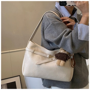 Détail du grand sac cabas crème en simili cuir avec breloque d'ours mignonne