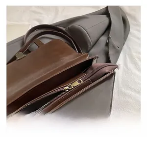 Macro detail of the interior compartment and vintage golden metal zipper of the brown handbag
