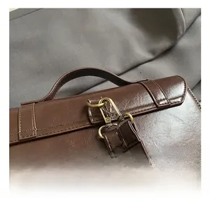 Detail of retro dark brown leather backpack handle and high-quality brass hardware hooks