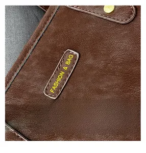Detailed close-up of dark brown leather texture with rivets and neat stitching work