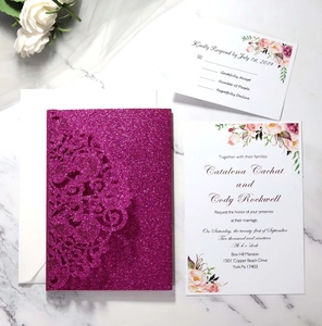 Macro view of purple glitter laser-cut wedding invitation set with floral inner cards