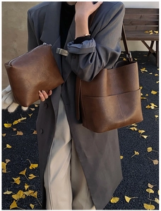 Dettaglio della borsa a secchiello marrone vintage con pochette coordinata