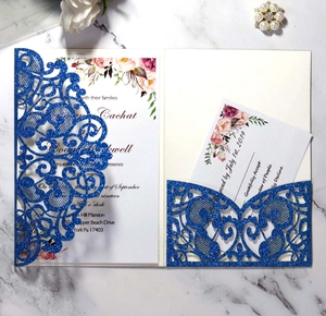 Detail of laser-cut glitter wedding invitation set with navy blue envelope and floral insert