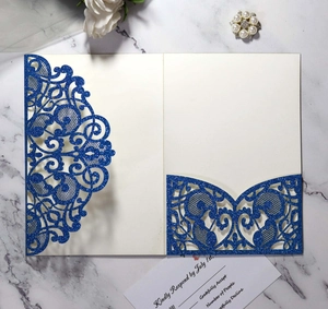 Detail of laser cut navy blue glitter wedding invitation with floral patterns