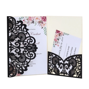 Detail of laser-cut glitter wedding invitation with floral card and RSVP card