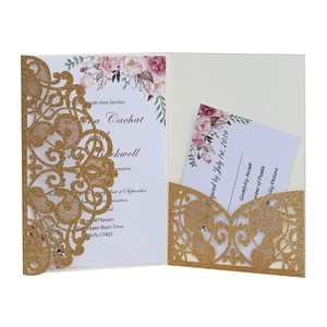 Glittering gold laser-cut wedding invitation set with floral inserts and RSVP cards