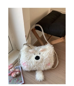 Detail of white plush polar bear shoulder bag featuring soft faux fur and cute animal face