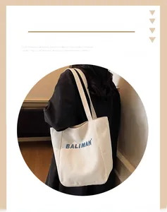 Close-up of Baliman blue letter embroidery on the white canvas tote bag detail