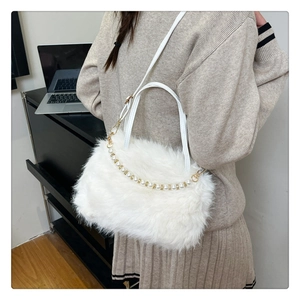 Borsa a mano in peluche bianca con manico di perle e tracolla in un moderno ufficio