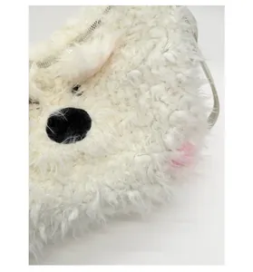 Close-up of white plush backpack featuring soft faux fur texture and cute cartoon facial details