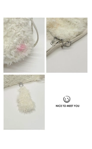 Close-up of white plush crossbody bag with pink gradient detail and silver metal buckle