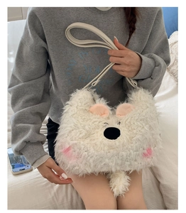 Detailed view of white faux fur animal shaped shoulder bag worn with casual grey hoodie