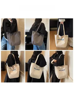 Various angles of large canvas tote bags in grey and beige with BALIMAN lettering