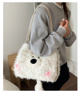 Detail of white fluffy plush bear shoulder bag showing soft faux fur and cute embroidery