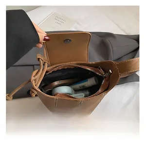 Top view of brown bucket bag interior showing spacious storage for phone and cosmetics