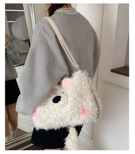 Detailed close-up of soft white plush animal crossbody bag with curly faux fur texture