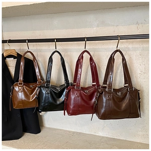Showcase of four glossy oil wax leather Boston bags in brown, black, burgundy and coffee