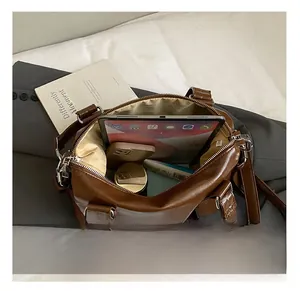 Top view of brown retro leather bag showing large capacity for tablet and daily items