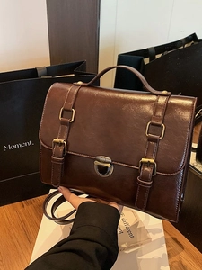 Vintage brown leather messenger bag with top handle and crossbody strap for women