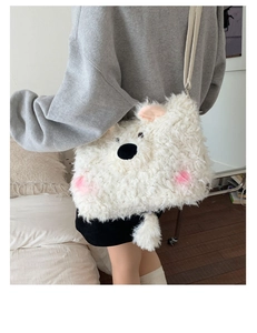 Detail of white plush bear bag worn by model showing its soft texture and large capacity