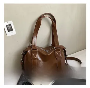 Detail showing deep brown vintage tote bag with PU leather texture and silver hardware