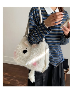Detailed close-up of a white fluffy teddy bear shoulder bag with soft plush texture