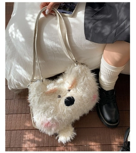 Detail of white plush Westie dog bag with fluffy texture and cream leather strap
