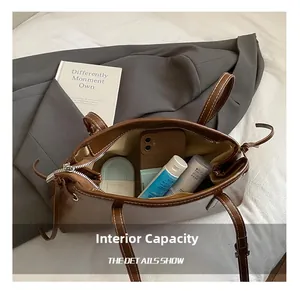 Top view of brown tote bag interior showing large capacity for phone and cosmetics