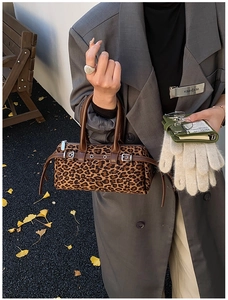 Macro detail of leopard print faux fur Boston bag with leather strap and metal buckle