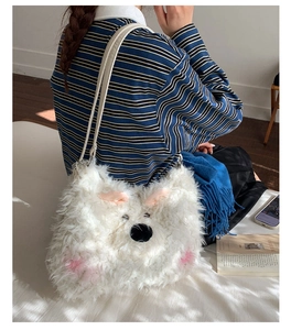 Detail of plush white dog-shaped shoulder bag featuring fluffy faux fur and leather strap