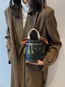Retro black cylinder bucket bag with leopard scarf and gold zippers on brown blazer outfit
