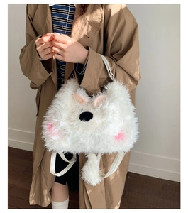 Close-up of white plush animal-shaped backpack with soft fur and cute embroidered details