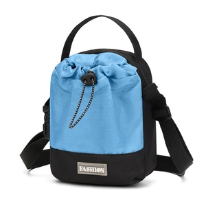 Detail van een mini nylon crossbodytas met trekkoord en blauw-zwart contrastontwerp
