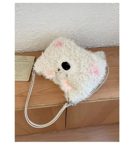 Close-up of white plush koala bag detail with soft faux fur and pink ear accents