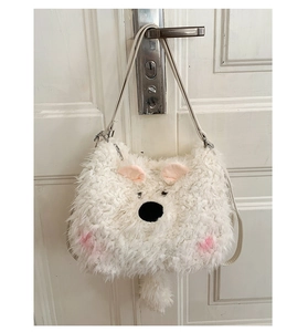 Detail of white plush animal bag with pink ears and metal zipper hanging on a door