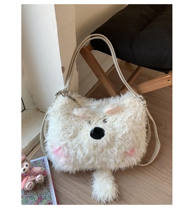Detail showing plush white puppy bag with pink ears and silver zipper closure