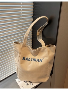 Beige canvas tote bag with blue BALIMAN embroidery and long straps for women's daily commute