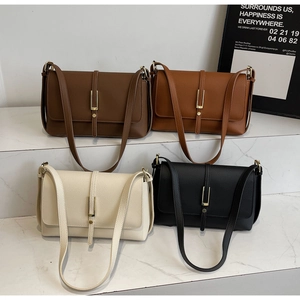 Group shot of leather crossbody bags in four colors with gold U-shaped metal buckles