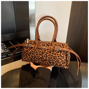 Close-up of leopard print barrel bag with suede texture and metallic silver hardware