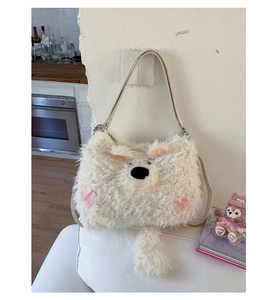 Detail of cute cream fuzzy bear bag with plush tail and removable leather strap on sofa