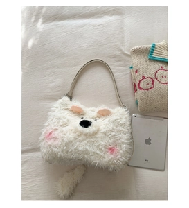 Detail of white fluffy animal shaped plush tote with soft ears and a cute tail charm