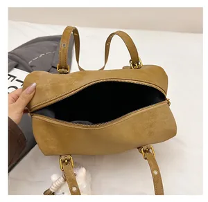 Top view of spacious interior in a khaki vintage pillow bag with smooth black lining