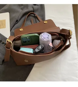 Interior view of brown lychee grain leather shoulder bag with spacious storage capacity