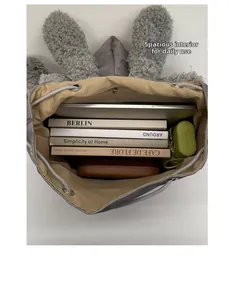 Interior espacioso de la mochila de peluche gris con forma de conejo para libros y tablet