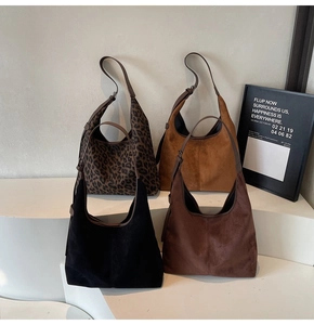 Detail view of large matte hobo bags in leopard print, yellow, black and brown colors