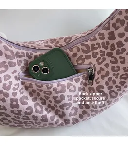 Detail showing back anti-theft zipper pocket on purple leopard print tote bag